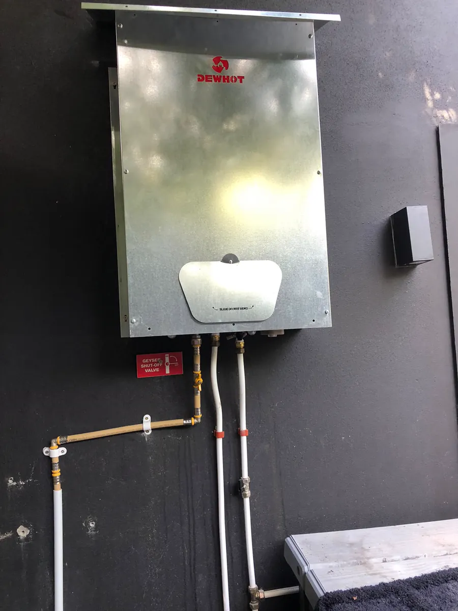 Dewhot gas geyser installed by Red Flame Gas Supplier in Cape Town, with a labelled shut-off valve and clipped gas and water lines